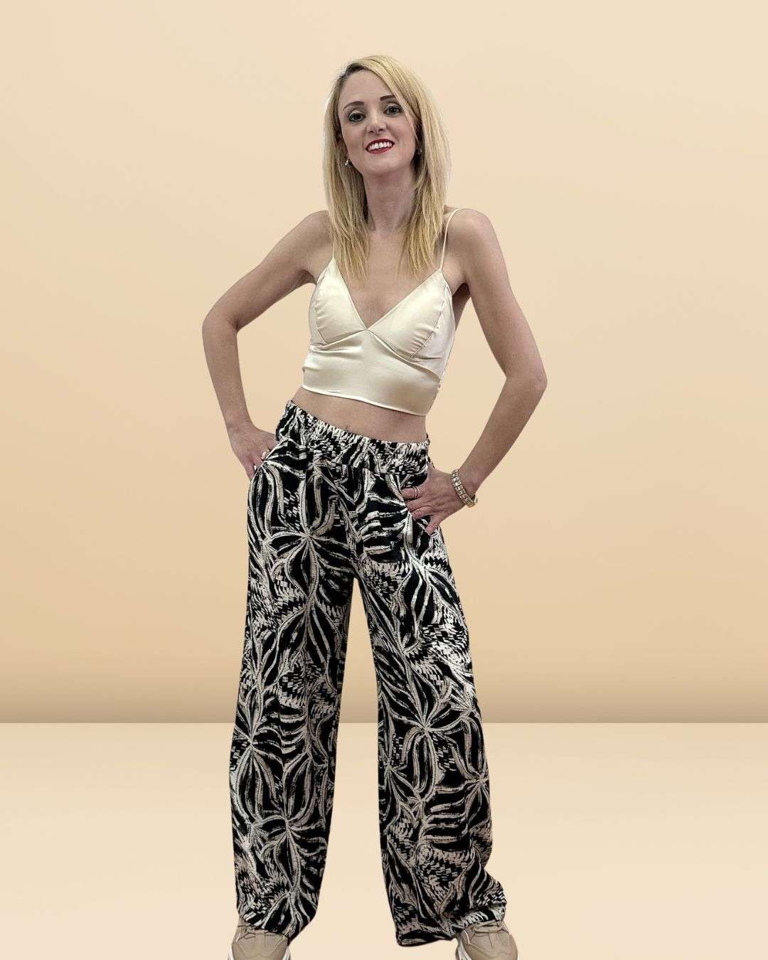 Μοντέρνα παντελόνα σε εμπριμέ σχέδιο ( μαύρο)  με απαλούς τόνους, για τις καλοκαιρινές σας εξορμήσεις. Σε άνετη γραμμή με τσεπούλες και λάστιχο στη μέση για καλύτερη εφαρμογή. Διαθέσιμο σε χρώματα Μαύρο, Λαδί, Σιέλ και Ώχρας, αποτελεί την ιδανική επιλογή για boho-chic και άνετα ντυσίματα.